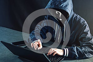 Anonymous hacker uses a laptop to hack the system. Creation and