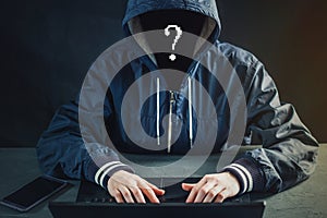 Anonymous hacker uses a laptop to hack the system. Stealing personal data. Creation and infection of malicious virus.