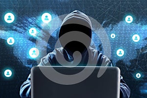 Anonymous hacker using laptop on technology background