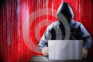 Anonymous hooded hacker, binary code - cyber attack concept