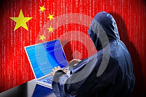 Anonymous hooded hacker, flag of China, binary code - cyber attack concept