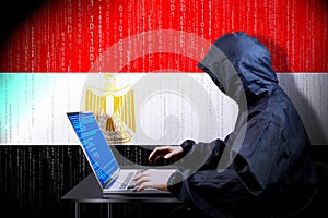 Anonymous hooded hacker, flag of Egypt, binary code - cyber attack concept