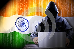 Anonymous hooded hacker, flag of India binary code - cyber attack concept