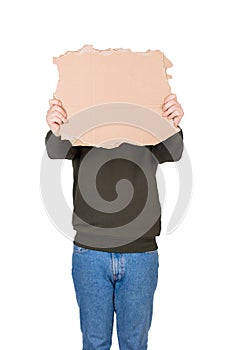 Anonymous man covers his head with a blank cardboard sheet, copy space for messages. Empty banner for advertising. Incognito