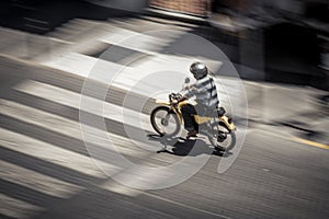 Anonymous man riding motorbike on street