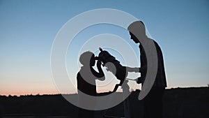 Man and boy using telescope