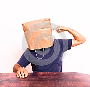 Anonymous pensive man with paper bag on his head