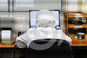 Anonymous person in office in front of computer