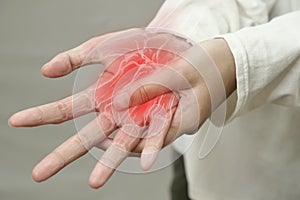 Anonymous person touching her wrist, suferring from arthritis disease