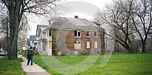 Anonymous Person Walks Sidewalk Derelict Abandoned Houses Detroit