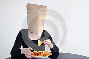 Anonymous woman blindly eats unhealthy food