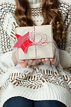 Anonymous woman holding beautifully wrapped present