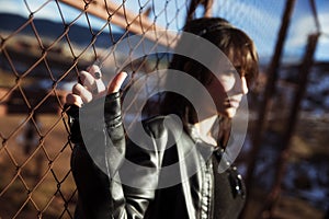 Anonymous woman portrait over fence photo