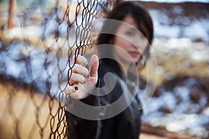 Anonymous woman portrait over fence photo