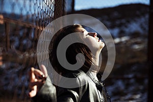 Anonymous woman portrait over fence photo