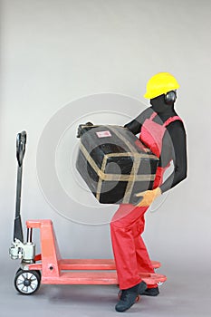 Anonymous worker lifting  heavy package. Profile view.