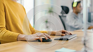 Anonymous Young Woman Sitting at Her Desk Using Laptop Computer. Focus on Hands Using Mouse and Ke