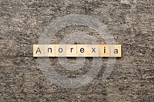 anorexia word written on wood block. anorexia text on table, concept