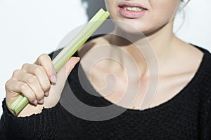 Anorexic girl eating a leek