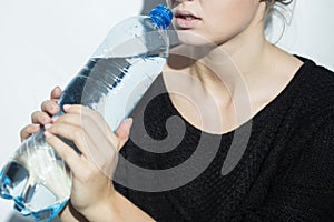 Anorexic girl holding a bottle of water