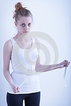 Anorexic girl with measuring tape