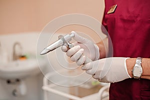 Anoscopes with ring lights in the hands of a doctor. Reusable Proctology Instruments