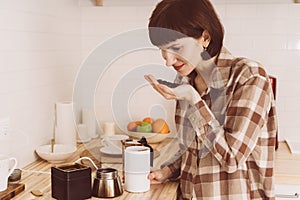 Anosmia, restore sense of smell. COVID-19 causes loss of smell. Happy woman sniffing coffee from hand