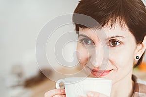 Anosmia, restore sense of smell, lossing due to COVID-19. Close up happy smiling woman sniffing coffee