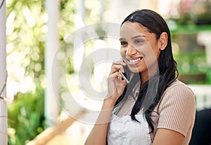 Another day in my organic paradise. a young florist using her smartphone to make a call.