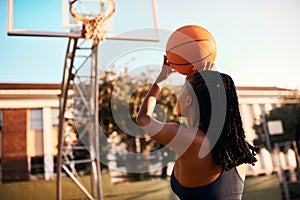 Another one bites the dust. Full length shot of an unrecognizable sportswoman playing basketball alone during the day.