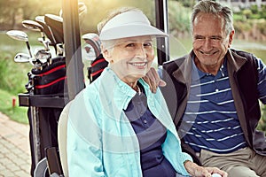 Another successful golfing day. Portrait of a smiling senior couple riding in a cart on a golf course.