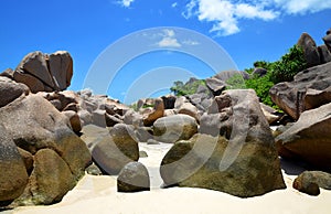 Anse Marron beach with big granite boulders on La Digue Island, Seychelles. Tropical landscape with sunny sky.