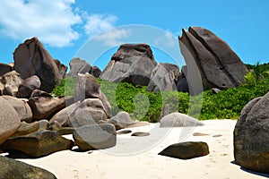 Anse Marron beach with big granite boulders on La Digue Island, Seychelles. Tropical landscape with sunny sky.