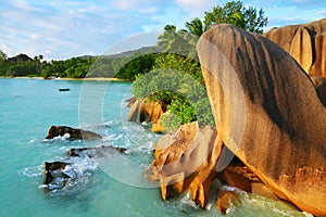 Anse Source d`Argent beach with big granite rocks at sunset. La Digue Island, Indian Ocean, Seychelles.