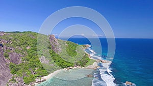 Anse Source D'Argent Beach in La Digue, Seychelles. Aerial view of tropical coastline on a sunny day