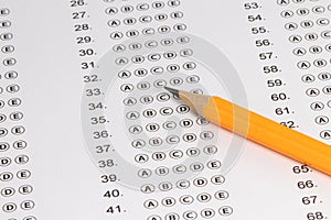 Answer sheet form with pencil on table, close up. Concept of passing exam