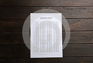 Answer sheet on wooden background