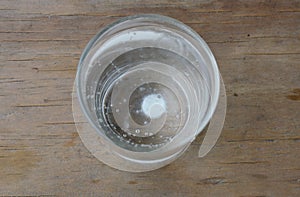 Antacids in water glass on wooden table