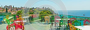 ANTALYA, TURKEY: Colorful chairs in the restaurant with a view of the sea and the old town in Antalya.