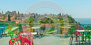 ANTALYA, TURKEY: Colorful chairs in the restaurant with a view of the sea and the old town in Antalya.