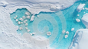 Antarcic iceberg turquoise melt hole aerial view