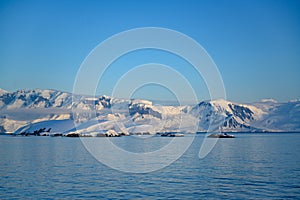Antarctic landscape with snowcapped mountains and glacier near Andvor Bay, Antactic Peninsular