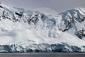 Antarctic mountain ridge; rock, snow and blue ice visible.