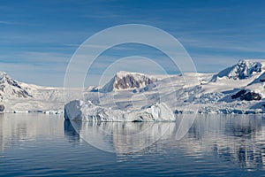 Antarctic seascape with iceberg and reflection