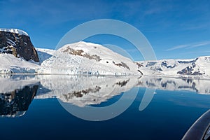 Antarctic seascape with iceberg and reflection