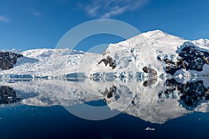 Antarctic seascape with icebergs and reflection