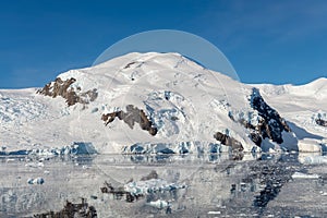 Antarctic seascape with icebergs and reflection