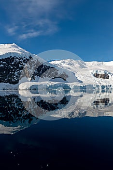 Antarctic seascape with icebergs and reflection