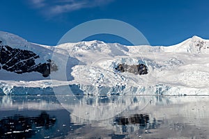 Antarctic seascape with icebergs and reflection