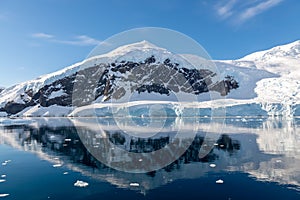 Antarctic seascape with icebergs and reflection